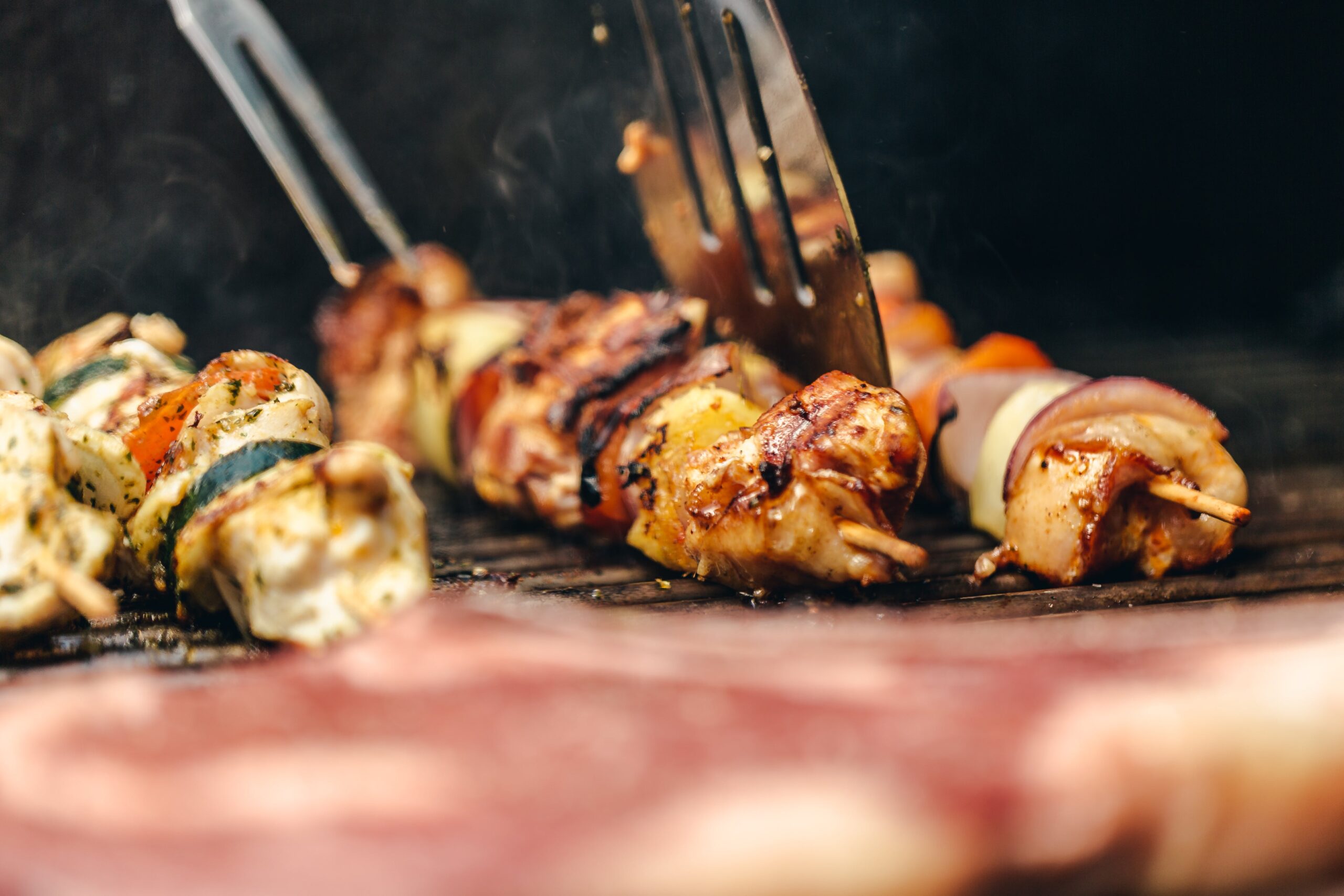 flipping-chicken-and-veggie-kabob-on-grill