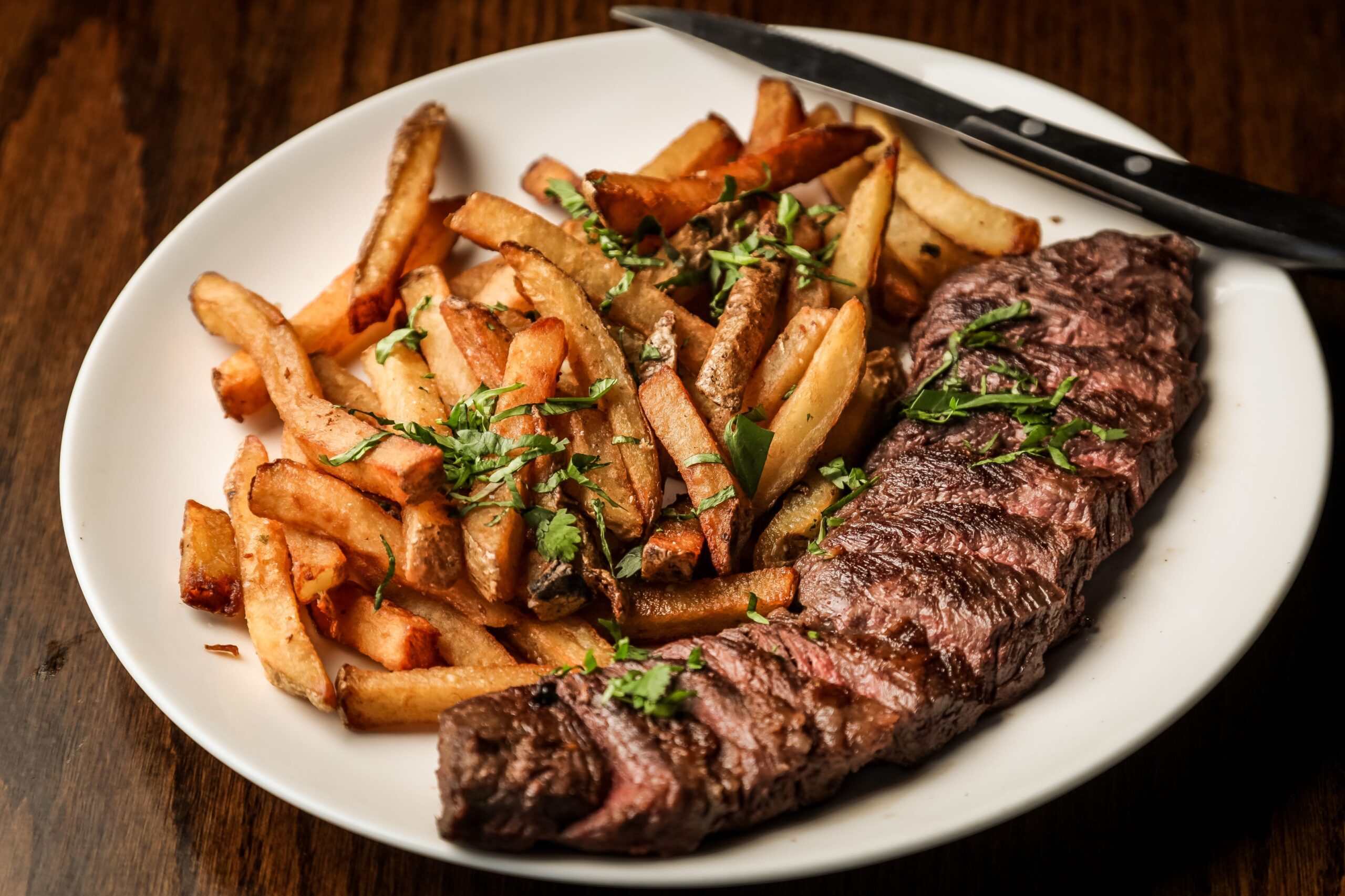 white-plate-with-fries-and-a-grilled-steak
